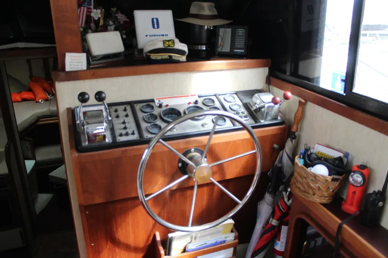 Slide: The Image of Interior helm of 1985 Carver 32 Convertible boat with steering wheel and controls. - 9