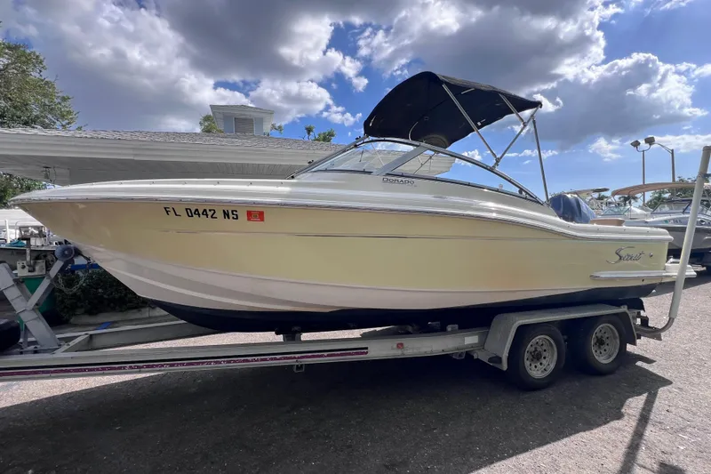 The Image of 2008 Scout 222 Dorado boat on trailer under a partly cloudy sky. - 0
