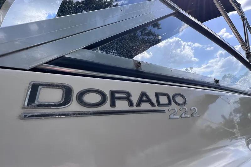 Slide: The Image of Close-up of 2008 Scout 222 Dorado boat nameplate under a sunny sky. - 10