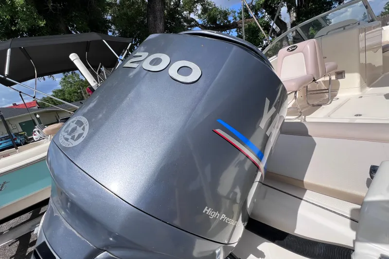 Slide: The Image of 2008 Scout 222 Dorado boat with Yamaha 200 outboard motor, docked outdoors. - 12