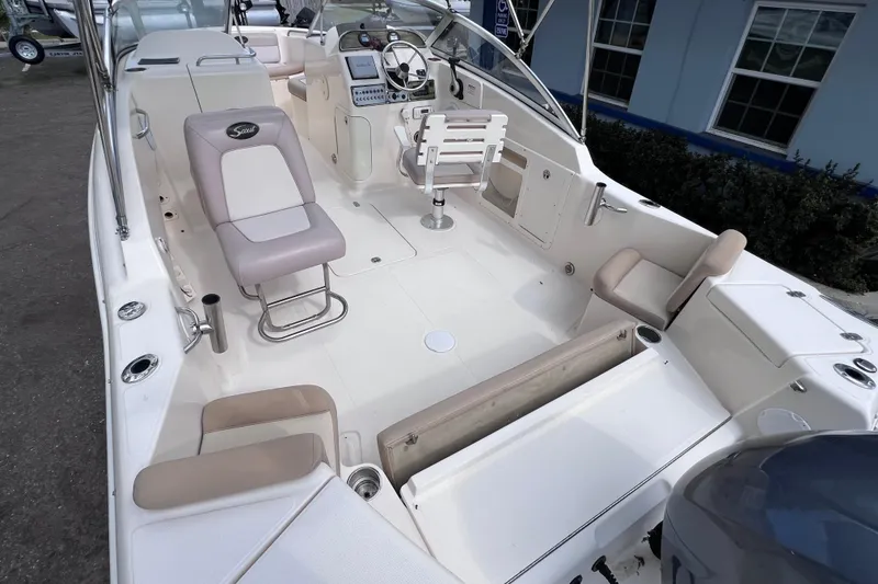 Slide: The Image of 2008 Scout 222 Dorado boat interior with seating and control panel. - 13