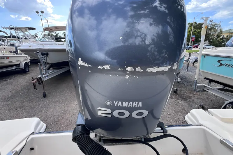 Slide: The Image of Yamaha 200 outboard motor on 2008 Scout 222 Dorado boat, parked outdoors. - 16