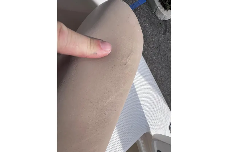 Slide: The Image of Finger pointing at a scratch on the 2008 Scout 222 Dorado boat seat. - 19