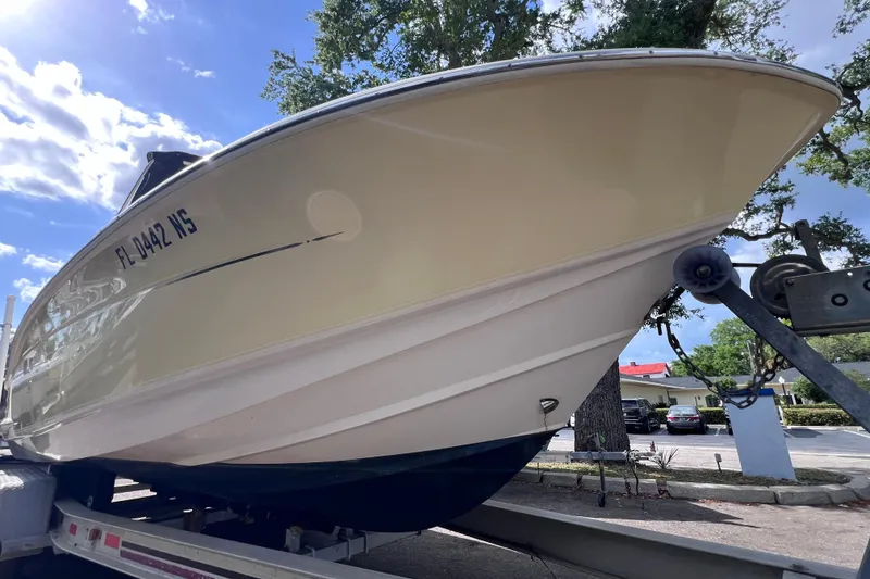 Slide: The Image of 2008 Scout 222 Dorado boat on trailer under sunny sky. - 2