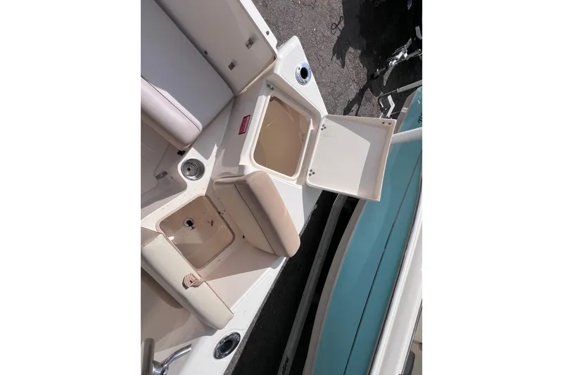 Slide: The Image of 2008 Scout 222 Dorado boat interior with open storage compartments. - 20