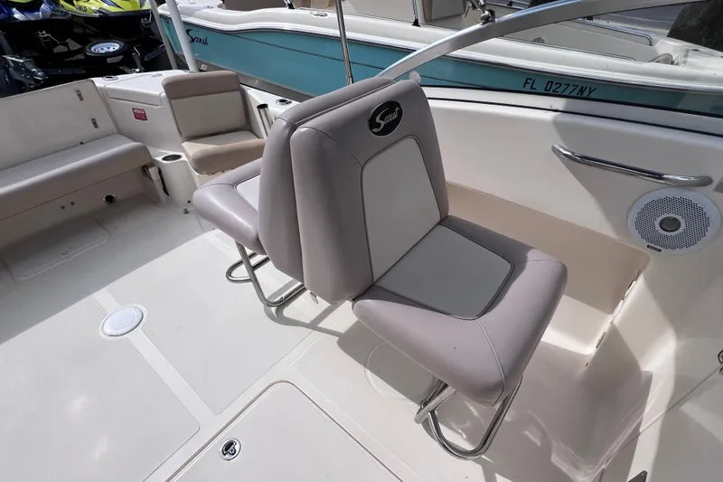 Slide: The Image of 2008 Scout 222 Dorado boat interior with cushioned seating and speaker. - 23