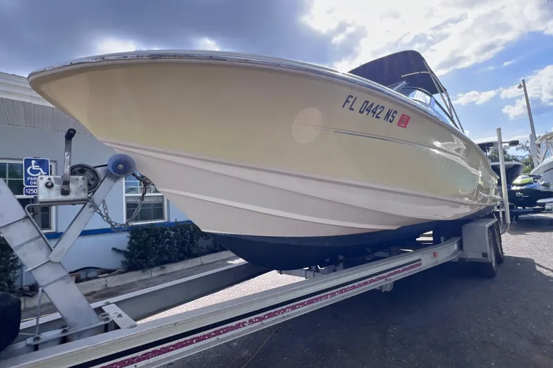 Slide: The Image of 2008 Scout 222 Dorado boat on trailer, parked outdoors under a partly cloudy sky. - 3