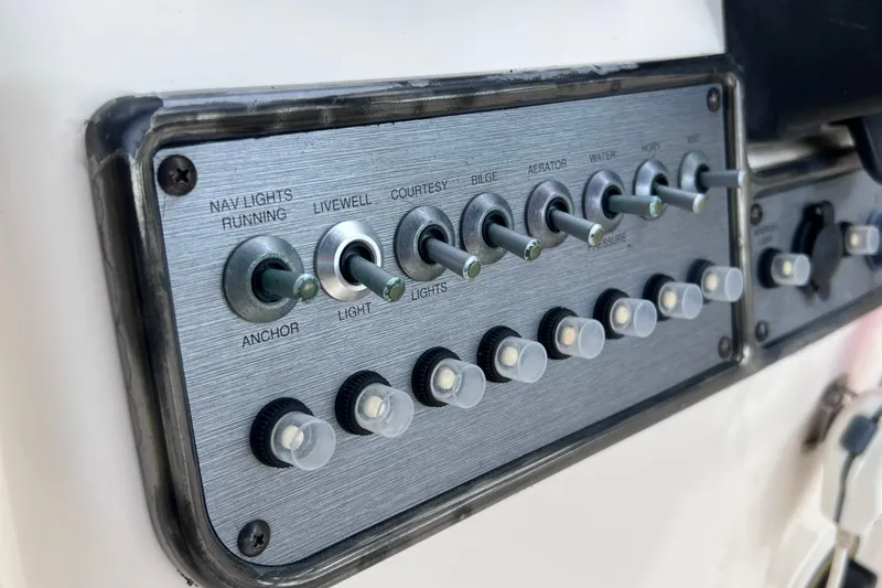 Slide: The Image of Control panel of a 2008 Scout 222 Dorado boat with labeled switches. - 30