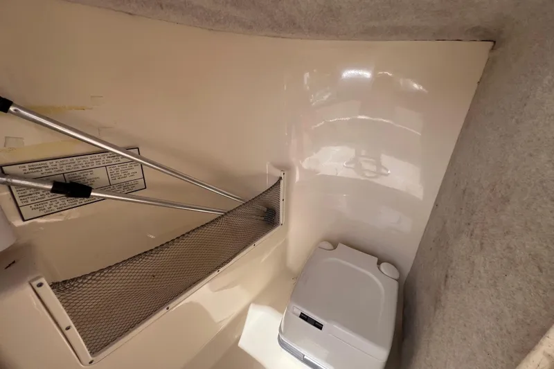 Slide: The Image of Interior of 2008 Scout 222 Dorado boat with portable toilet and storage net. - 33