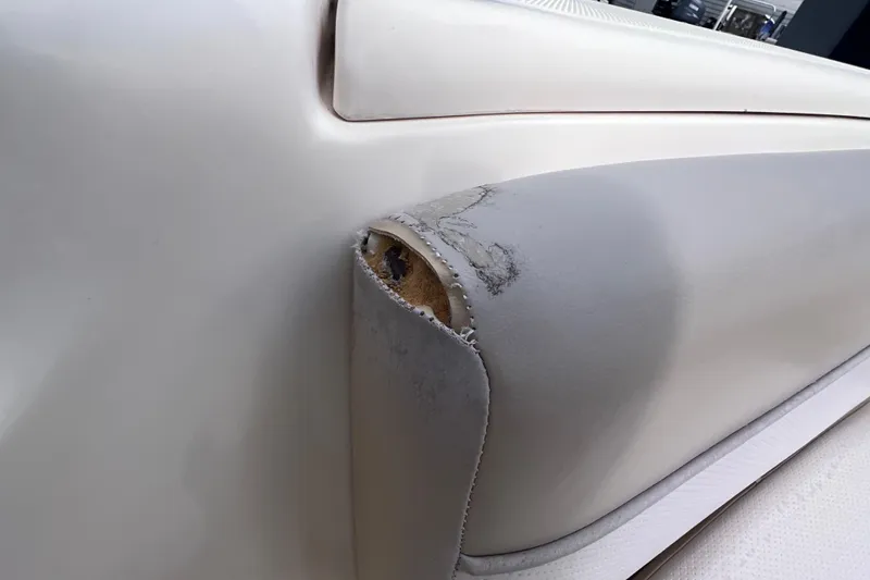 Slide: The Image of Damaged upholstery on a 2008 Scout 222 Dorado boat seat, showing wear and tear. - 38