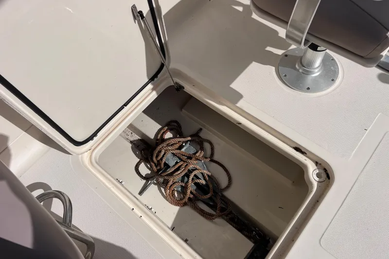 Slide: The Image of Open storage compartment on 2008 Scout 222 Dorado boat with coiled rope inside. - 42