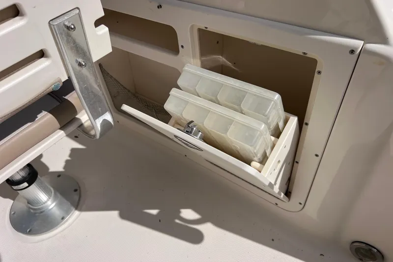 Slide: The Image of Storage compartment on a 2008 Scout 222 Dorado boat with tackle boxes. - 43