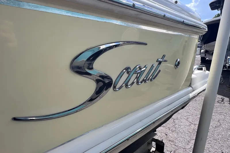 Slide: The Image of Close-up of 2008 Scout 222 Dorado boat logo on beige hull. - 9