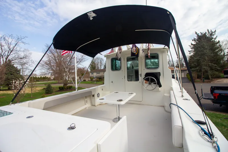 Slide: The Image of Parker 2520 XLD Sport Cabin 2022 with covered cockpit and table. - 12