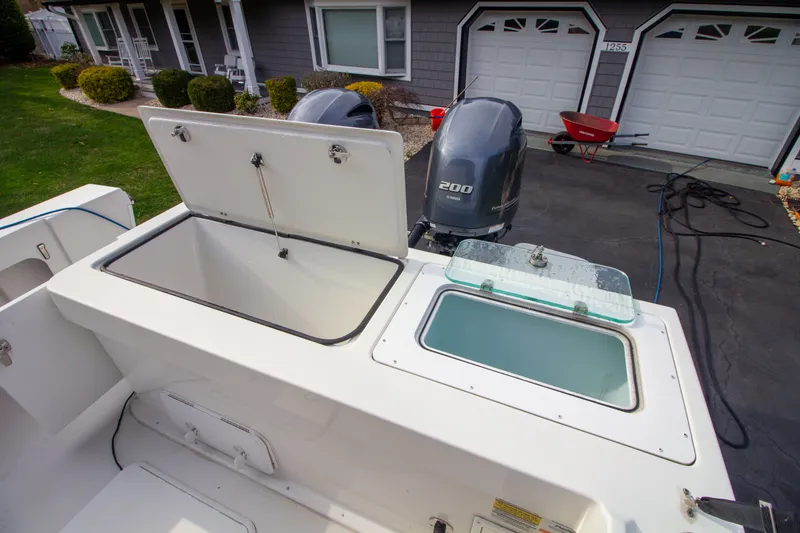 Slide: The Image of Parker 2520 XLD Sport Cabin 2022 with open storage and engines. - 14