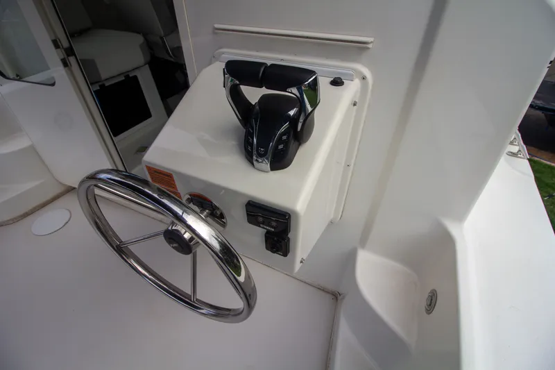 Slide: The Image of 2022 Parker 2520 XLD Sport Cabin helm with steering wheel and throttle control. - 18