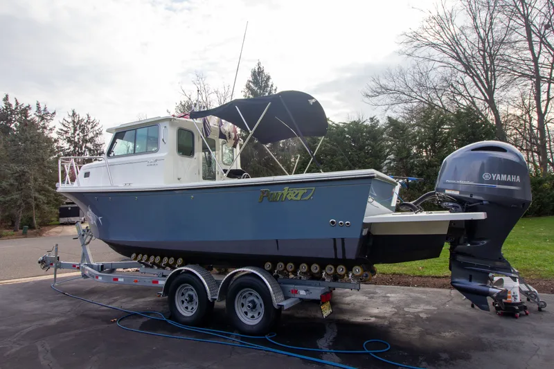 Slide: The Image of Parker 2520 XLD Sport Cabin 2022 on trailer with Yamaha engine. - 2