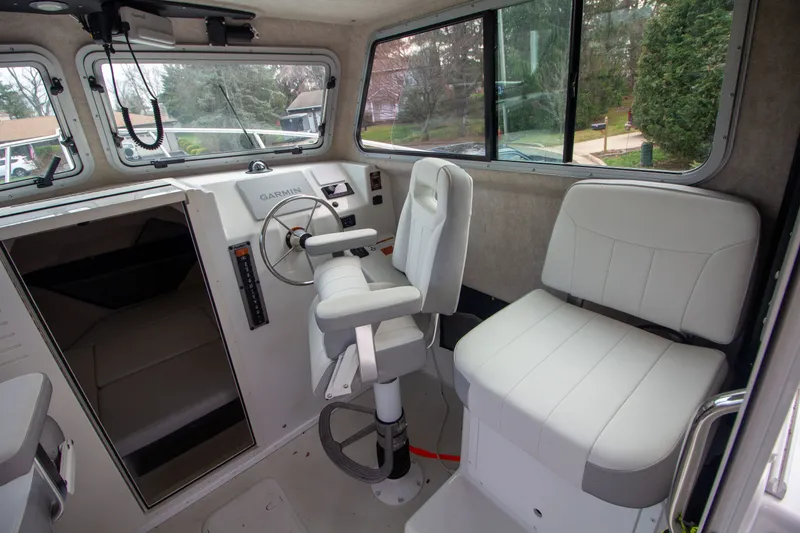 Slide: The Image of Interior of 2022 Parker 2520 XLD Sport Cabin with helm station. - 26