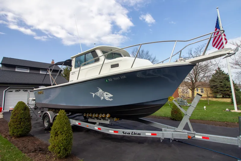 Slide: The Image of 2022 Parker 2520 XLD Sport Cabin on trailer in driveway. - 6