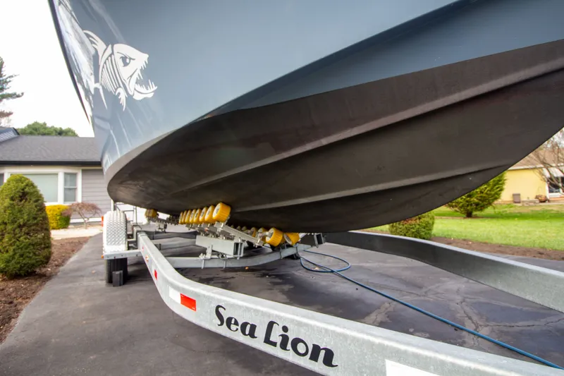 Slide: The Image of Parker 2520 XLD Sport Cabin 2022 on trailer, close-up of hull. - 9