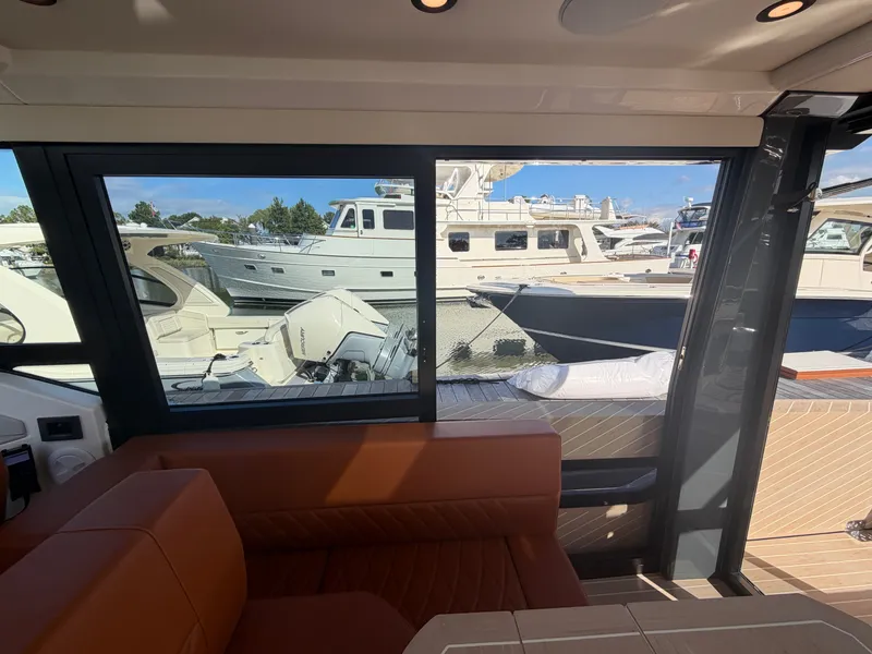 Slide: The Image of Interior view of a 2027 Saxdor 400 GTC overlooking the marina. - 14