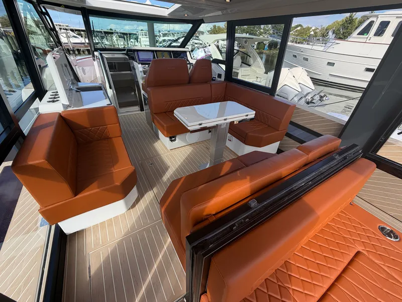 Slide: The Image of The image shows the interior of a Saxdor 400 GTC with sleek brown leather seating and a table. - 10