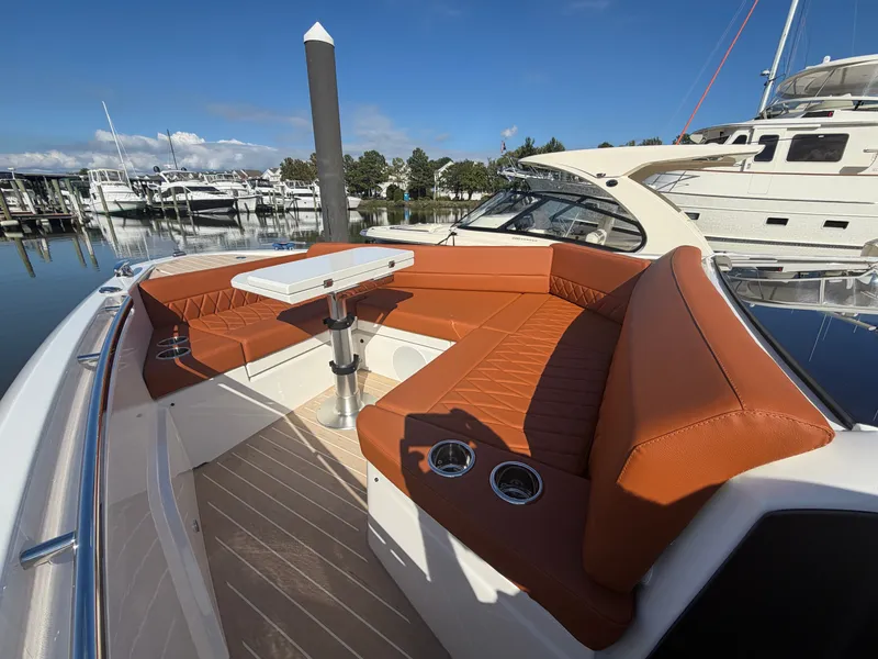 Slide: The Image of The image shows the bow of a 2027 Saxdor 400 GTC with brown leather seating and a table. - 27