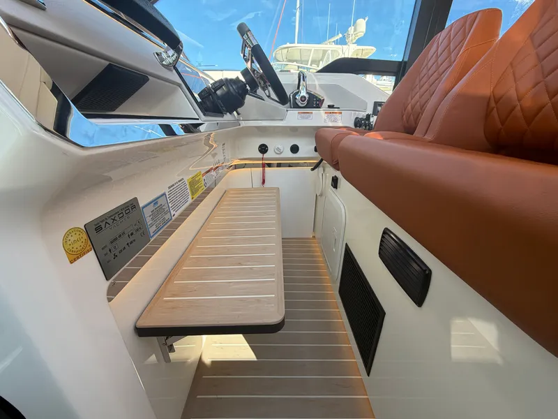 Slide: The Image of Interior of a Saxdor 400 GTC with brown leather seats and a modern helm station. - 21