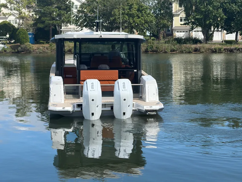 Slide: The Image of A 2027 Saxdor 400 GTC with twin outboard engines on calm water. - 6