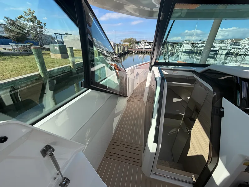 Slide: The Image of 2027 Saxdor 400 GTC with modern design, spacious deck, and large windows at the dock. - 24