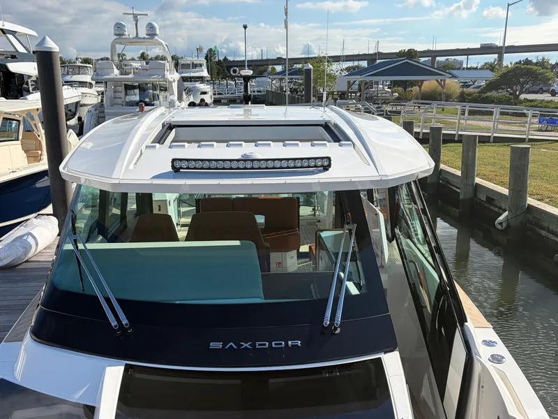 Slide: The Image of The image shows a Saxdor 400 GTC boat from 2027 docked at a marina. - 31