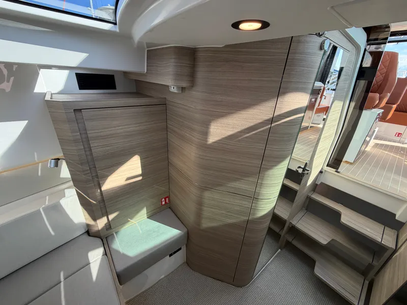 Slide: The Image of Interior of a 2027 Saxdor 400 GTC with modern wood accents and stairs leading to the deck. - 41