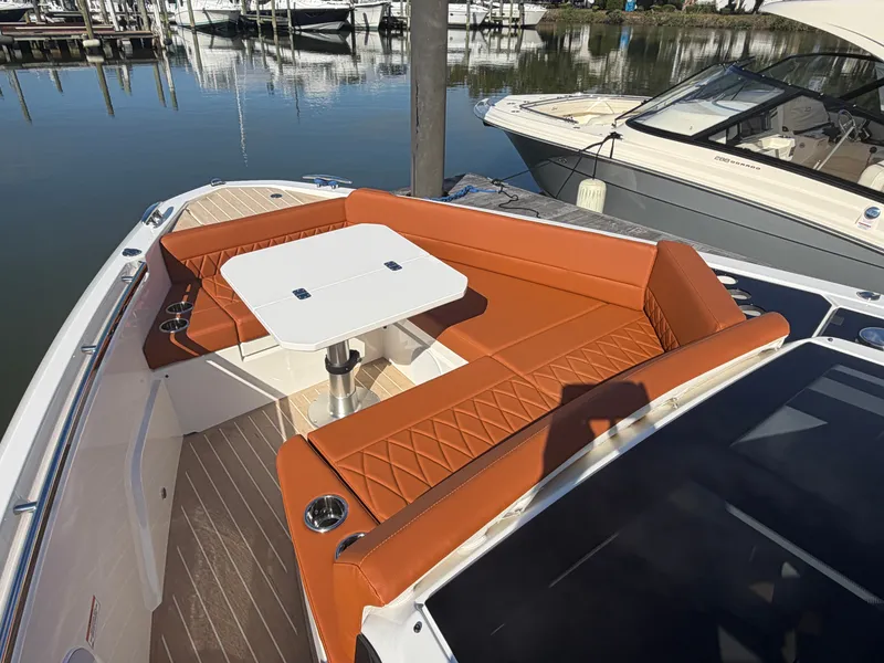 Slide: The Image of The image shows the foredeck of a Saxdor 400 GTC with orange seating and a table. - 28