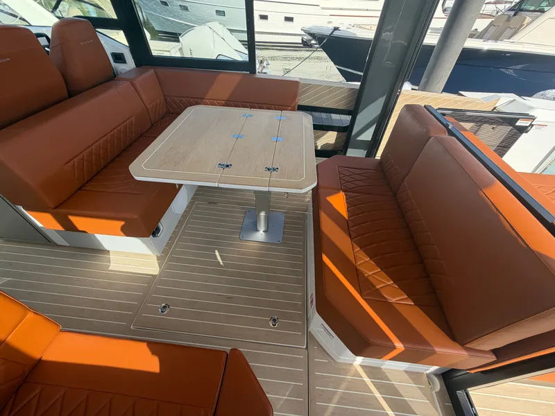 Slide: The Image of The interior of the 2027 Saxdor 400 GTC features a stylish seating area with a wooden table. - 13