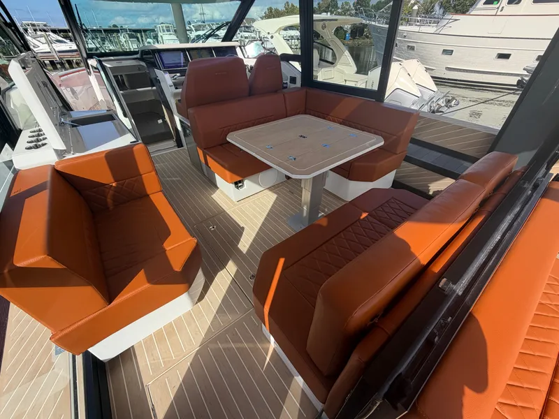 Slide: The Image of The 2027 Saxdor 400 GTC interior features stylish orange seating and a central table. - 12