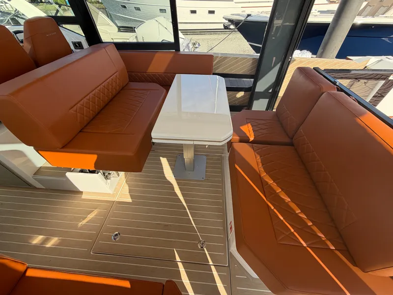 Slide: The Image of Interior of the Saxdor 400 GTC with orange seating and a white table. - 11