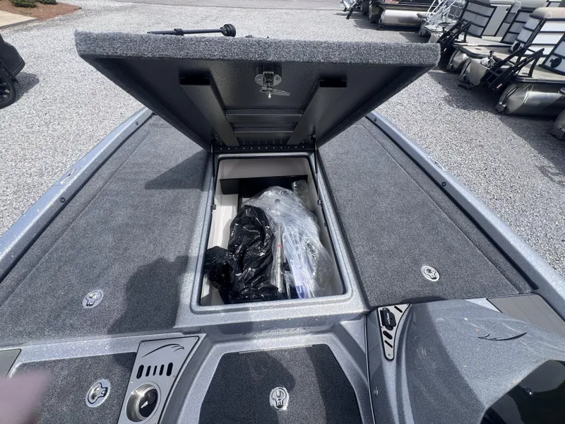 Slide: The Image of Falcon F205 2024 boat with open storage compartment on gray carpet. - 12