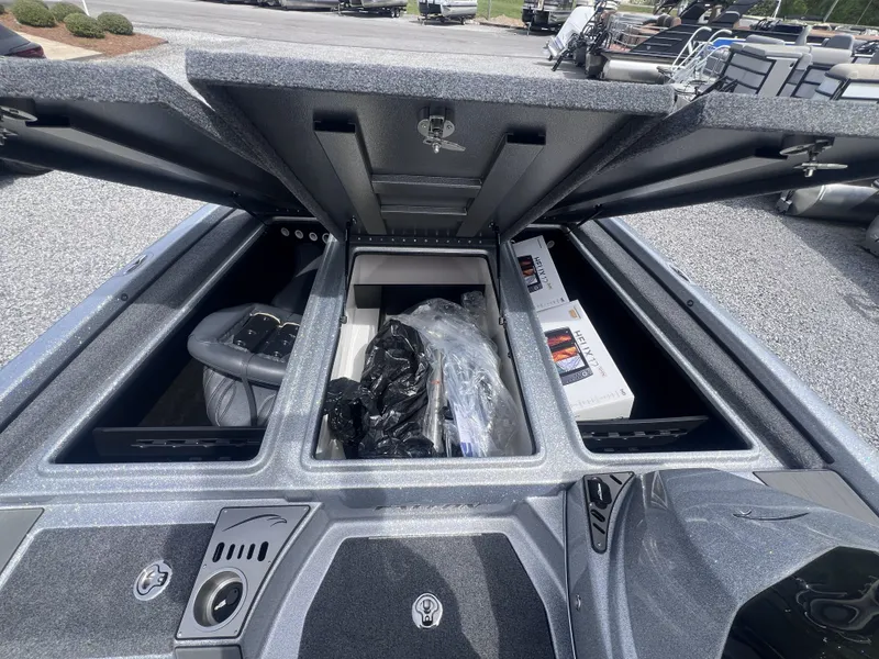 Slide: The Image of Falcon F205 2024 boat with open storage compartments and accessories. - 13
