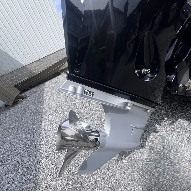 Slide: The Image of Falcon F205 2024 outboard motor with shiny propeller on gravel surface. - 16