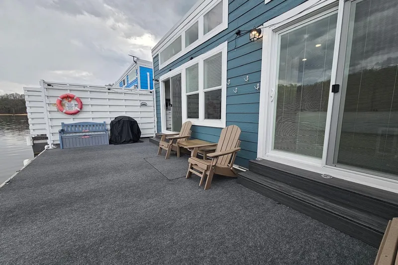 Slide: The Image of Modern 2025 houseboat with deck chairs, sliding doors, and waterfront view. - 20