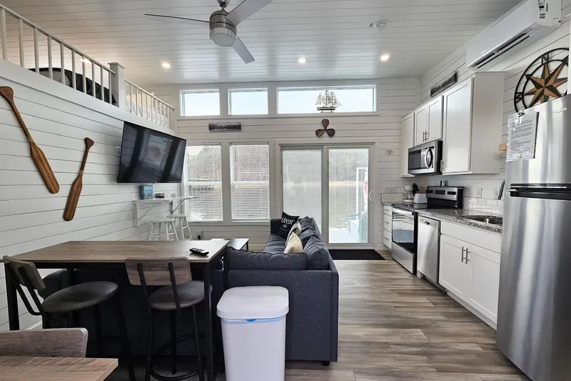 Slide: The Image of Modern 2025 houseboat interior with kitchen, living area, and nautical decor. - 3