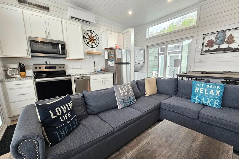 Slide: The Image of Modern 2025 houseboat interior with cozy living area, kitchen, and decorative pillows. - 6