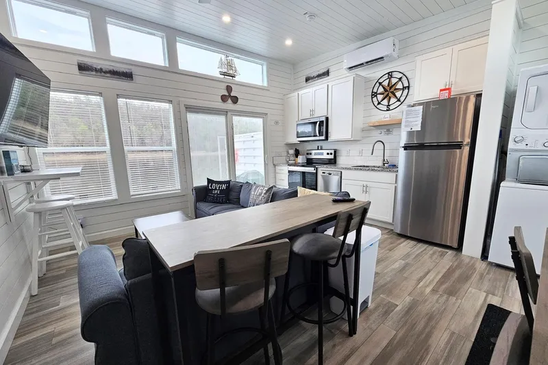 Slide: The Image of Modern 2025 houseboat interior with kitchen, dining area, and natural light. - 7