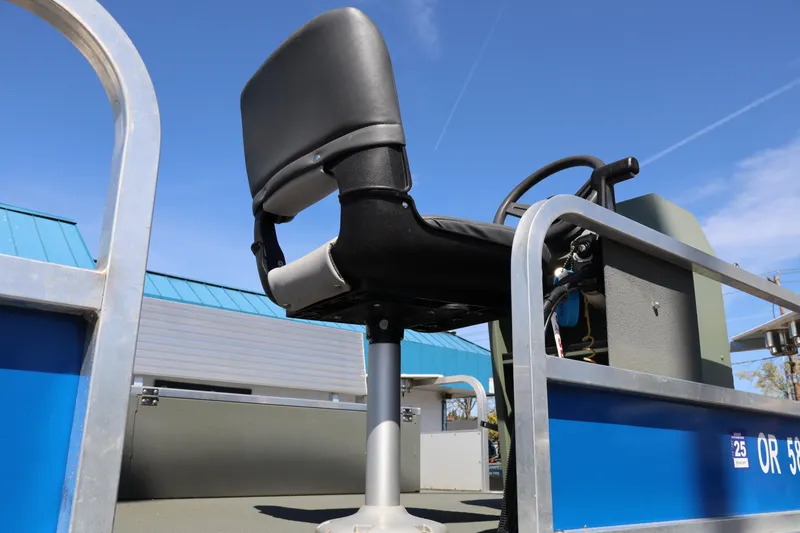 Slide: The Image of 2020 Ag Dryer Laker Pontoon with steering wheel and seat, under clear blue sky. - 6