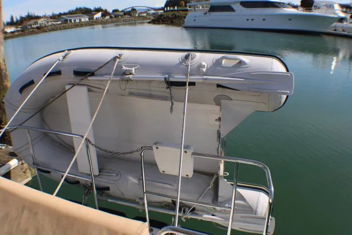 Slide: The Image of 2019 Ranger Tugs R-31 CB with dinghy on davit at marina. - 15