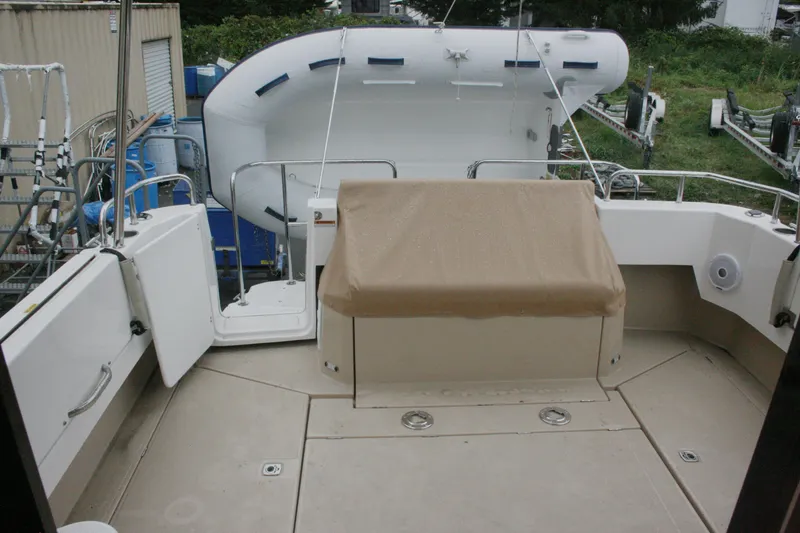 Slide: The Image of 2019 Ranger Tugs R-31 CB boat deck with covered seating and inflatable dinghy. - 17