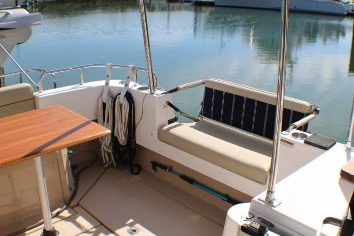 Slide: The Image of 2019 Ranger Tugs R-31 CB boat interior with seating and table by the water. - 19