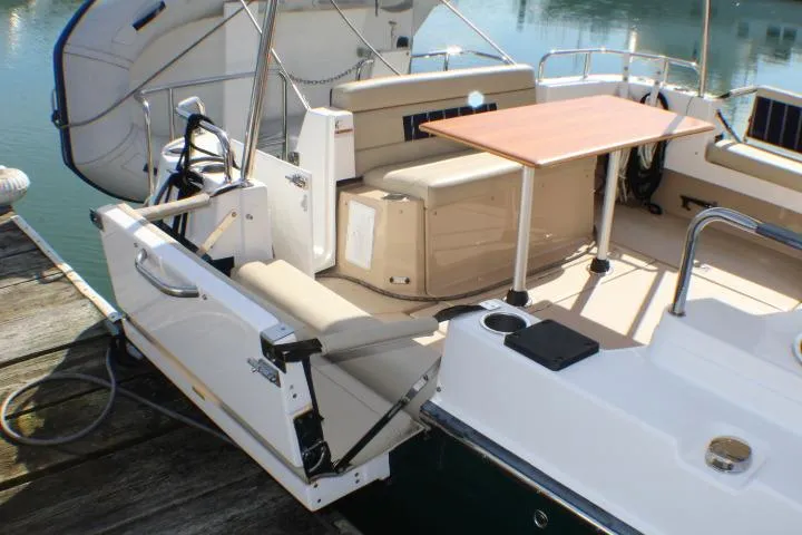 Slide: The Image of 2019 Ranger Tugs R-31 CB boat interior with seating and table, docked by water. - 20