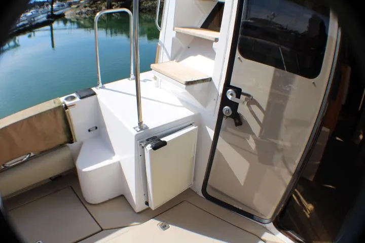 Slide: The Image of 2019 Ranger Tugs R-31 CB boat deck with open door and steps. - 23