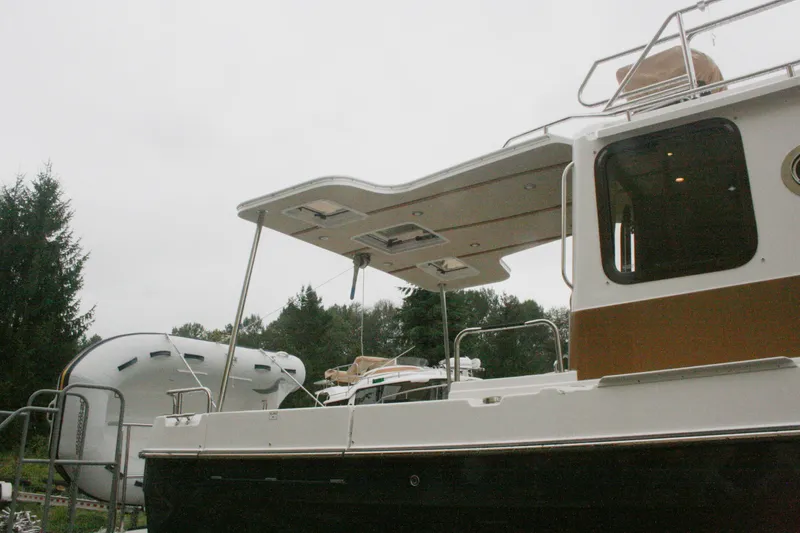 Slide: The Image of 2019 Ranger Tugs R-31 CB boat with canopy, docked outdoors. - 24